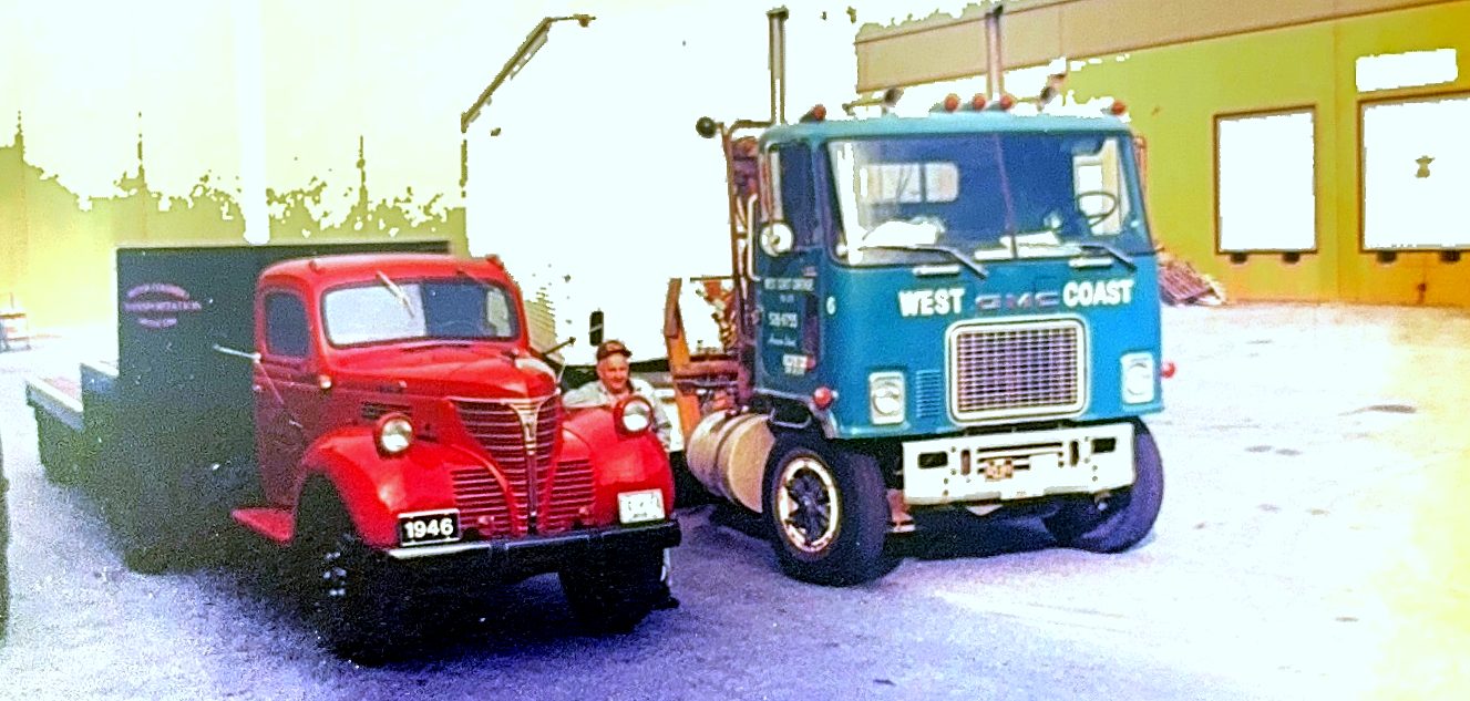 A 1946 flat deck truck parked beside a West Coast Cartage GMC cab-over